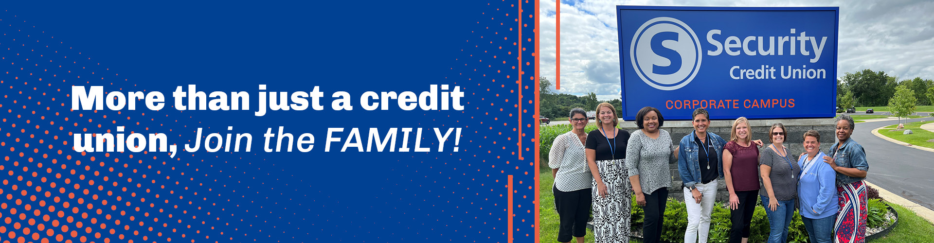 The Credit Union team standing by the exterior corporate sign.